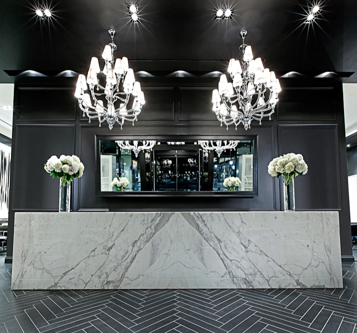 Dramatic dark marble salon reception with chandelier lighting